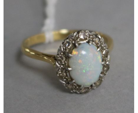 A gold and platinum, white opal and diamond oval cluster ring, size Q.