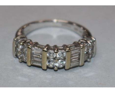 An 18ct white gold and diamond half hoop ring set with five cluster of round or baguette cut stones, size M.