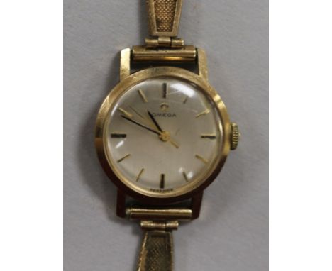 A lady's 9ct gold Omega manual wind wrist watch, on 9ct gold bracelet.