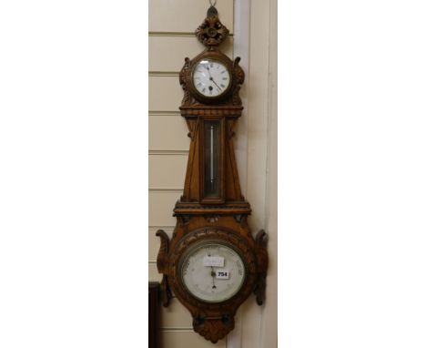 A carved oak barometer, W.30cm