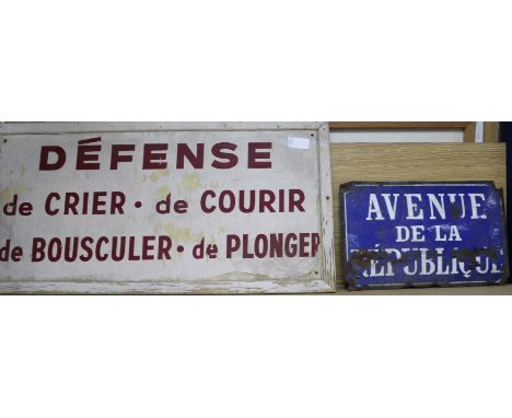 An enamel sign and a painted wood sign
