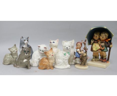 Two Hummel figures of children and a collection of cat figures by Royal Doulton, Beswick and Belleek