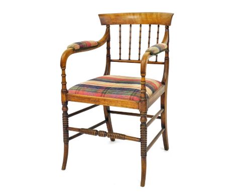 A 19thC beech open armchair, with spindle turned supports, padded arms and seat upholstered in tartan fabric, on ring turned 