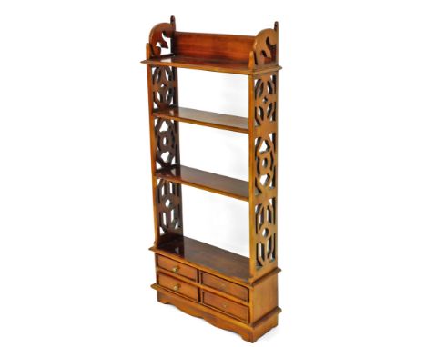 A Georgian style mahogany wall shelf, with pierced sides and an arrangement of four drawers, 107cm high, 50cm wide.