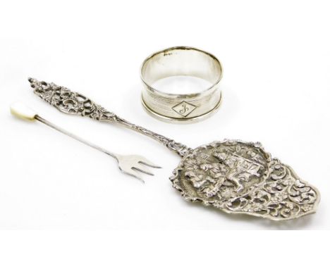 A Continental white metal server or slice, with a pierced scroll and floral cast handle, the flat bowl repousse decorated dep