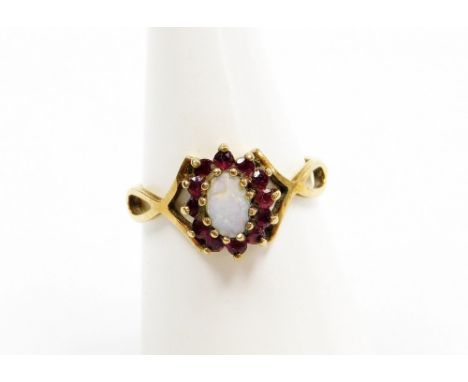 A 9ct gold dress ring, central cluster set with opal and garnet on twist shoulders, ring size N, 1.8g all in.  