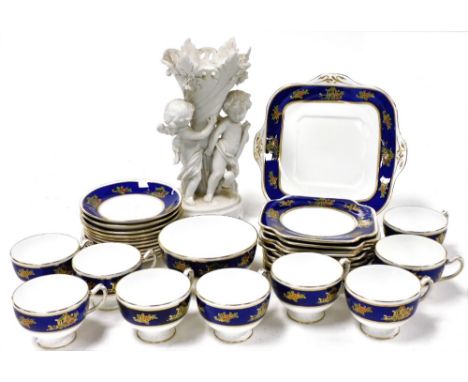 A Grafton China late 19thC porcelain tea service, decorated with pagodas and flowers against a cobalt blue ground, comprising