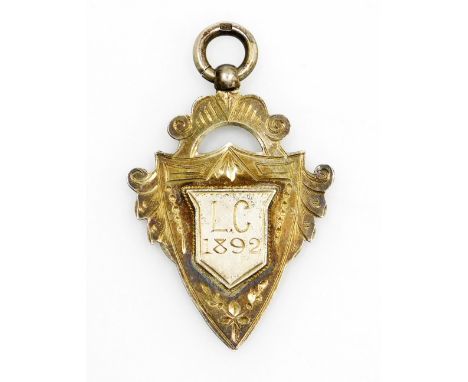 A silver gilt shield fob, central shield bearing initials L.C 1892, 9.5g.  