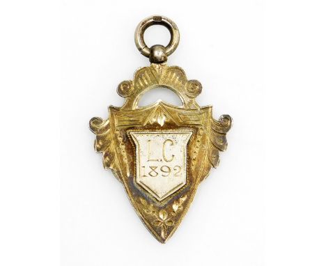 A silver gilt shield fob, central shield bearing initials L.C 1892, 9.5g.  