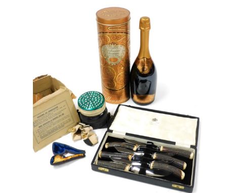 A bottle of Sainsburys Millennium Champagne, vintage 1995, with outer tin, a World War II respirator, dated April 1937, boxed