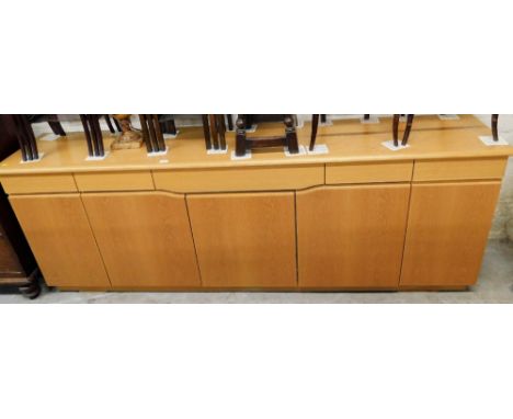 A Skovby Danish light oak sideboard, with an arrangement of cabinets and drawers, 86cm high, 233cm wide, 47cm deep. 