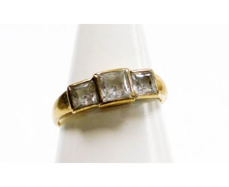 A 9ct gold three stone dress ring, set with three ash cut czs, in rub over setting, on a plain band, ring size P½, 2.6g all i