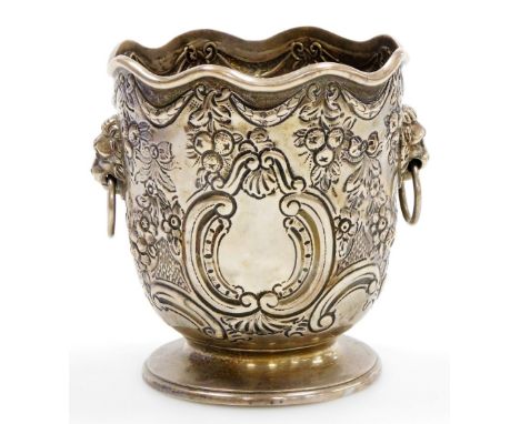 A Victorian silver bottle holder of Monteith form, with a waved rim, the body embossed with bows, swags, fruit, flowers and s