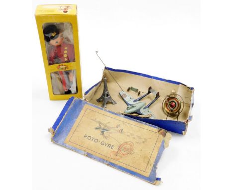 A French S.G.D.G tin plate roto-gyre, with Eiffel Tower base, in original box (AF), and a Pelham puppet, boxed. (2)  