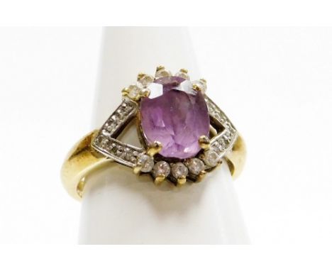 A silver amethyst and cubic zirconia set dress ring, the V splayed shoulders set with cz stones, surrounding a central amethy