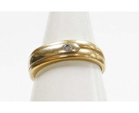 A 9ct gold dress ring, with three row banded design and set with tiny diamond, in tension setting, ring size T, 2.8g all in. 