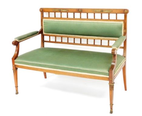 A continental mahogany and gilt metal salon sofa, with a padded back, arm rest and seat upholstered in green fabric, on squar