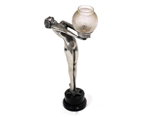 A metal finish resin Art Deco style table lamp, modelled in the form of a nude lady holding the fitting, on a circular base w