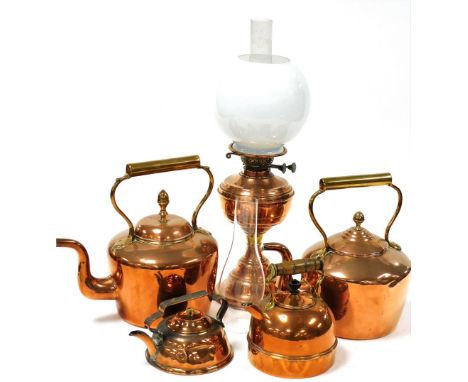 An early 20thC copper oil lamp, with chimney and globular white glass shade, further chimney, four Victorian and later copper