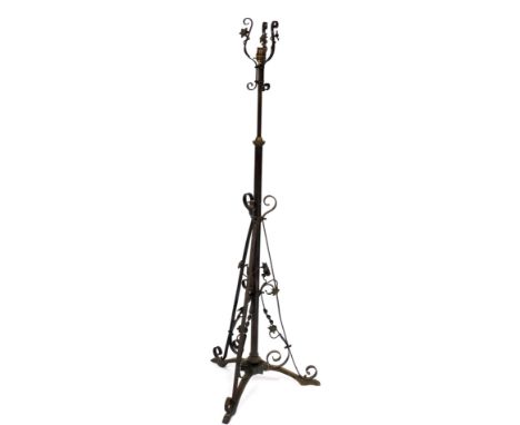 A late 19th/early 20thC brass adjustable floor lamp, decorated with flowers, scrolls, etc., in Art Nouveau style, converted t