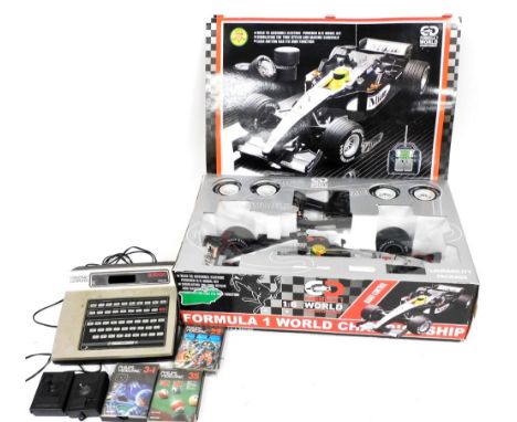 A Philips G7000 gaming console, with some games, and a Formula 1 World Championship radio controlled car.  