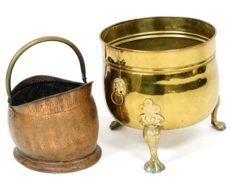 A brass log bucket, with lion's head and ring handles, raised on three cabriole legs and paw feet, 46cm high, together with a