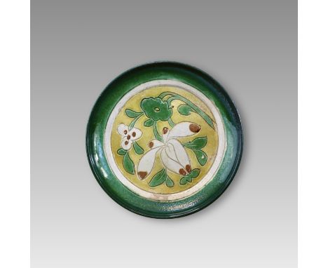 with shallow rounded sides supported on a short foot, the interior carved and decorated with a white-bordered medallion enclo
