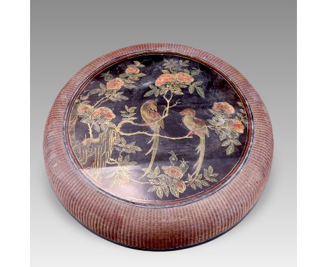 A circular painted lacquer box and cover with central medallion of birds and flowers, the rounded sides in basketwork. Inscri