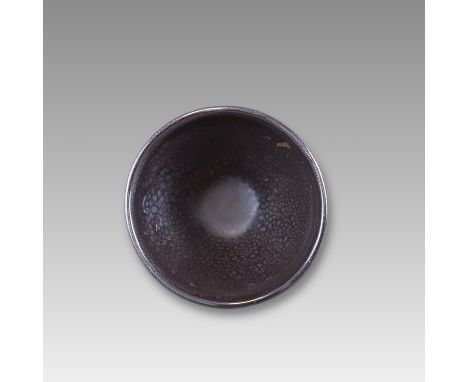 the deep, rounded conical sides covered in a thick black glaze suffused with a dense pattern of silver 'oil spots', the glaze