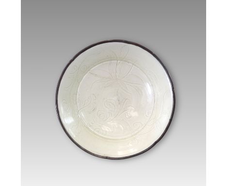 the shallow concave base supported on a neatly trimmed foot, rising to wide flaring sides and a six lobed rim, the interior f