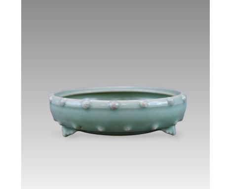 The censer of compressed wide drum form, raised on three ruyi-form feet and decorated around the rim and above the feet with 