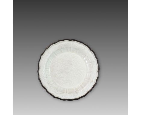 the centre of the shallow, flat-bottomed dish finely moulded with a design of a flower with leaves growing from a tripod vase
