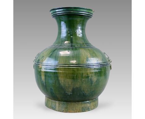 the rounded sides with applied taotie mask ring handles, covered with a deep green glaze Dimension: H:41cm Provenance: From G
