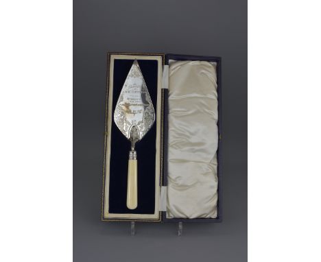 An English antique presentation trowel dated 13th August 1954. Length 35cm