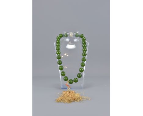 A green stone, possibly nephrite jade beaded necklace containing 25 beads. 1.5 cm each50