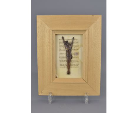 A bone crucifix carving on paper manuscript page. 17cm x 22cm