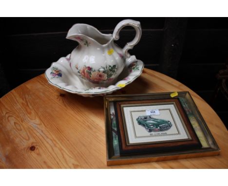 A small embroidery depicting E-type Jaguar; a coloured print of a car and a floral decorated wash jug and bowl 