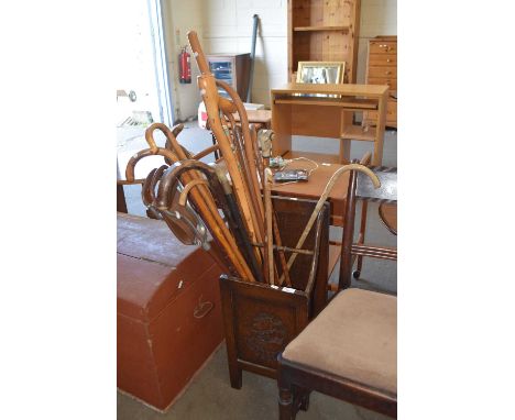 Stick stand containing a selection of various walking sticks