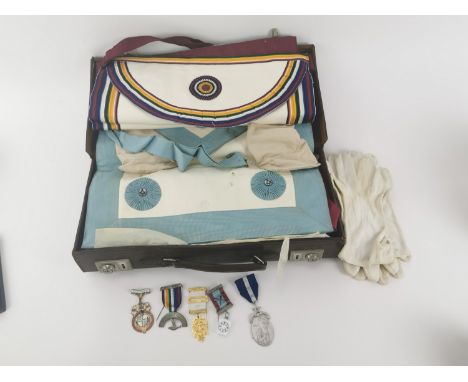 A collection of Masonic medals and clothing, to include a silver gilt breast jewel, a few silver medals and a 1954 enamelled 
