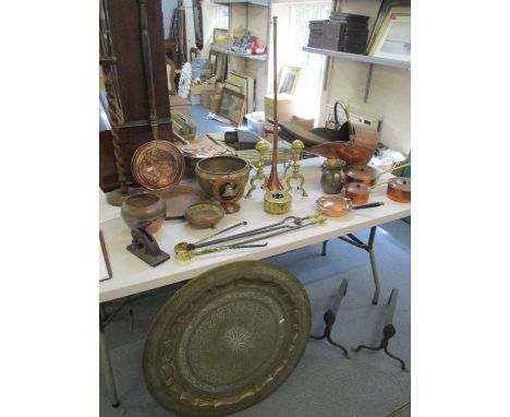 A collection of brass and copper to include a set of three saucepans, an art nouveau tray, bed pans and fire implement togeth