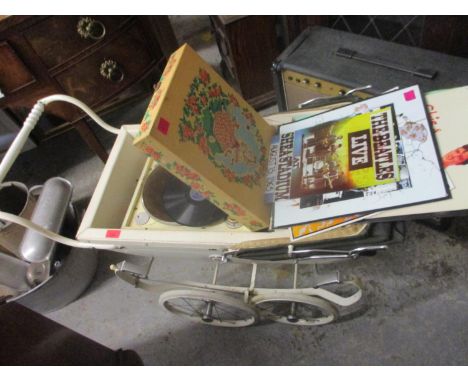 A Decca table top child's gramophone and reproduction pop metal posters and a child's Silver Cross pram Location: G 