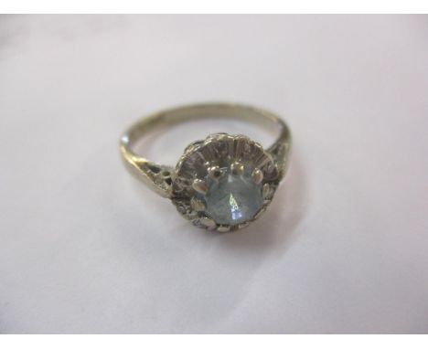 An 18ct gold white gold ring, size K, having a central pale blue sapphire stone surrounded by diamonds, total weight 3.3gLoca