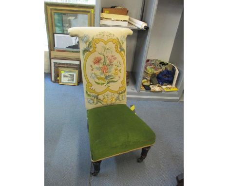 A Victorian prie dieu chair with tapestry upholstery, raised on ebonized legs and castorsLocation: SL 