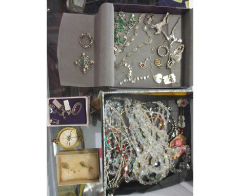 A selection of costume jewellery to include silver brooches, beaded necklaces, a compass and other jewellery 