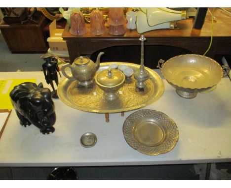 A mixed lot to include a carved ebony elephant, a carved ebony figure, a silver plated Islamic tea set, a silver plated punch