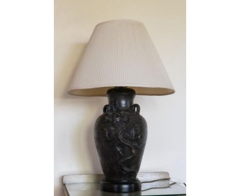 Oriental ceramic base electric lamp with raised dragon decoration, 70cm high