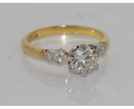 18ct yellow gold and platinum diamond ring set with a central round brilliant cut diamond 0.65ct, Colour K/L, VS2. Two small 