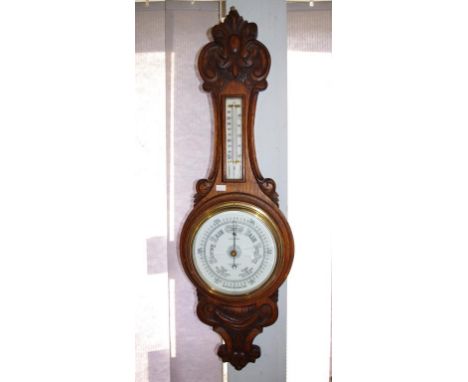 Stokes aneroid wall barometer on carved wood wall bracket, with  separate thermometer. (As inspected: glass cracked to barome