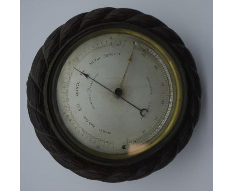 Late 19th century Holosterig barometer and thermometer set, with carved wood mounted brass case, 16.5cm diameter