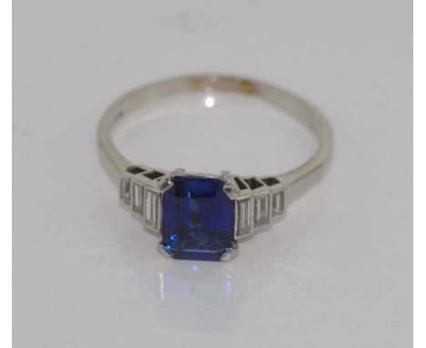 Art Deco platinum, diamond & sapphire set ring centre stone is emerald cut sapphire, approx 1.6ct, with three baguette cut di